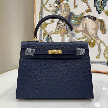 Deep Iris Navy Blue Tiny Raised Dot Compact Trapezoid Hand Carry Bag With Glossy Luminous Golden Twist Lock Hardware And Pale Contrast Edge Stitching