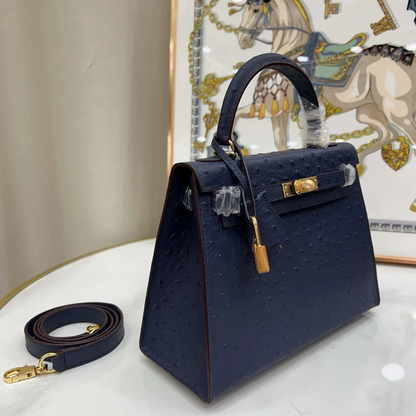 Deep Iris Navy Blue Tiny Raised Dot Compact Trapezoid Hand Carry Bag With Glossy Luminous Golden Twist Lock Hardware And Pale Contrast Edge Stitching