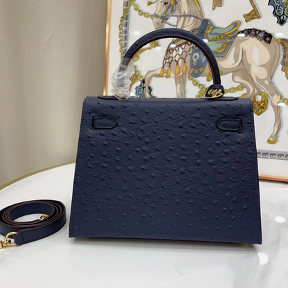 Deep Iris Navy Blue Tiny Raised Dot Compact Trapezoid Hand Carry Bag With Glossy Luminous Golden Twist Lock Hardware And Pale Contrast Edge Stitching