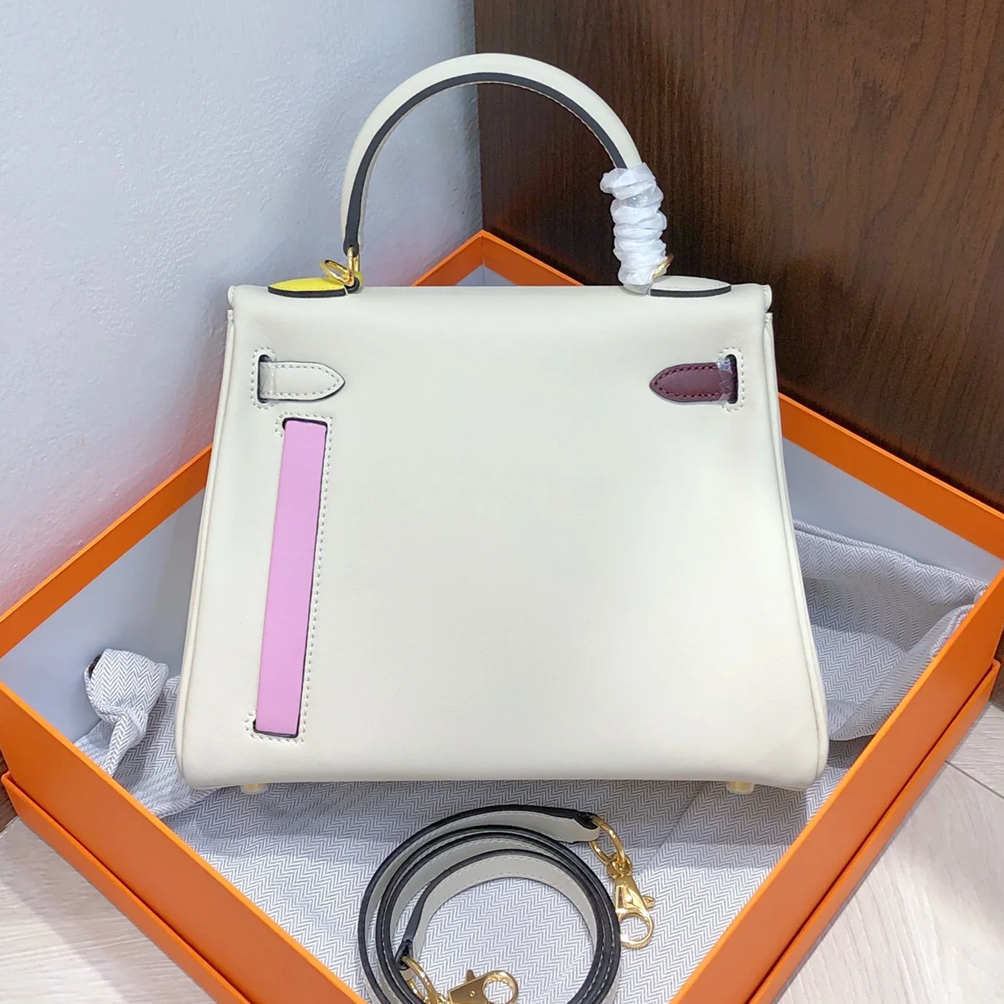 Creamy Off-White Multi-Tone Accent Compact Trapezoid Hand Carry Bag With Golden Twist Lock Hardware And Built-In Front Zippered Pocket